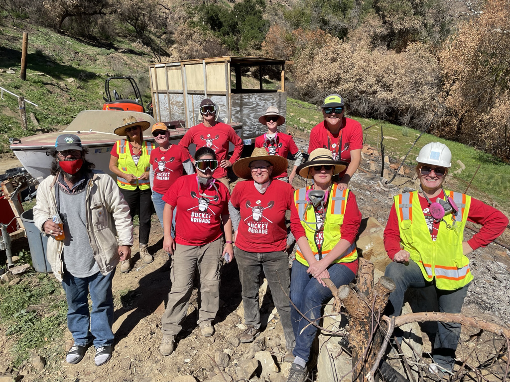 Volunteers remove and clean up debris after the Alisal Fire as a part of the Alisal Fire Assistance Project